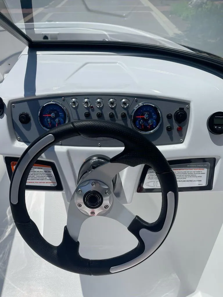 Slide: The Image of 2025 Tahoe 185 S boat dashboard with steering wheel and instrument panel. - 7