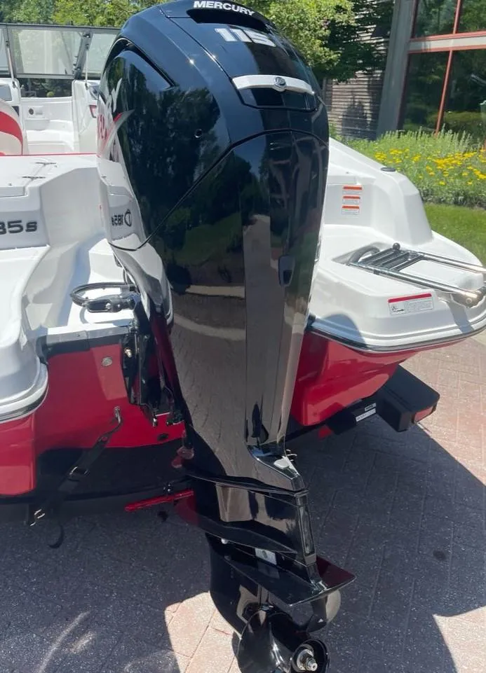 Slide: The Image of 2025 Tahoe 185 S boat with a Mercury outboard motor, parked outdoors. - 9