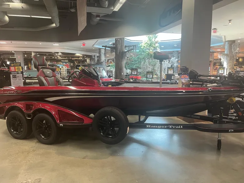The Image of 2025 Ranger Z519R Cup-Equipped boat displayed indoors, featuring sleek design and dual-axle trailer. - 0
