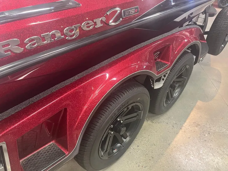 Slide: The Image of 2025 Ranger Z519R Cup-Equipped boat trailer with red metallic finish and black wheels. - 2