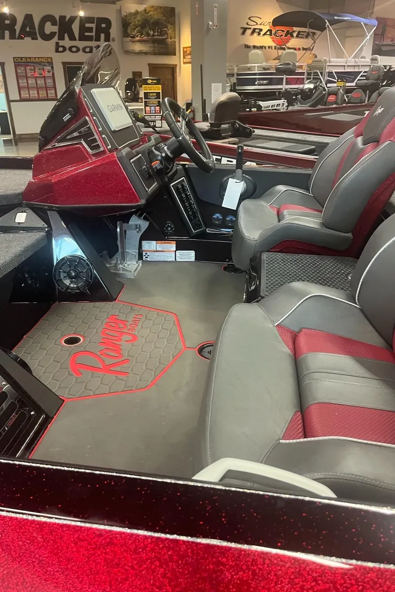 Slide: The Image of 2025 Ranger Z519R Cup-Equipped boat interior with red and gray seating, dashboard, and steering wheel. - 5