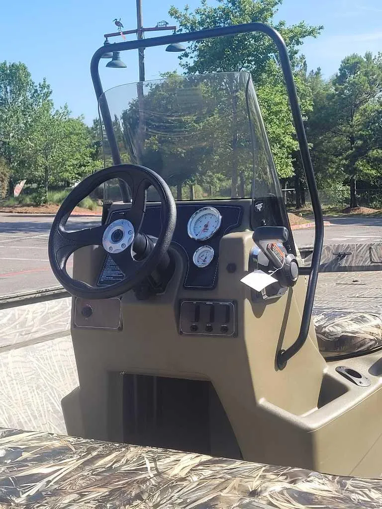 Slide: The Image of 2025 Tracker Grizzly 2072 CC boat console with steering wheel and gauges. - 3