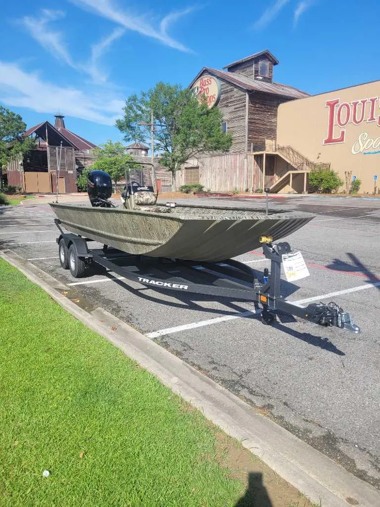 Slide: The Image of 2025 Tracker Grizzly 2072 CC boat on trailer in parking lot, sunny day. - 4