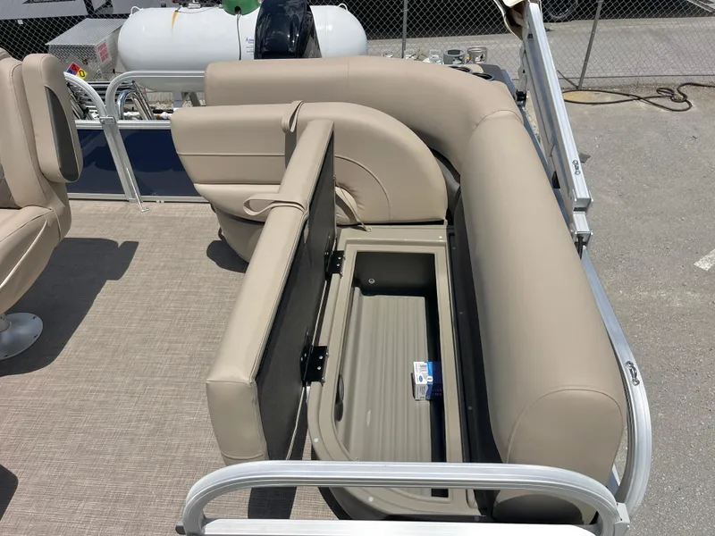 Slide: The Image of 2025 Sun Tracker Bass Buggy 16 XL Select pontoon with open storage compartment. - 5