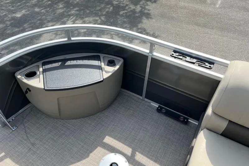 Slide: The Image of 2025 Sun Tracker Fishin' Barge 20 DLX interior with seating and storage area. - 11
