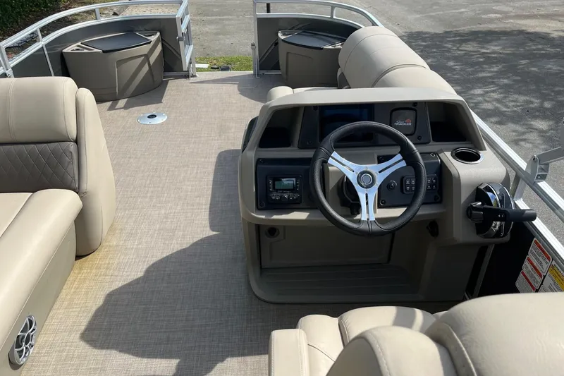 Slide: The Image of 2025 Sun Tracker Fishin' Barge 20 DLX interior with steering console and seating. - 6