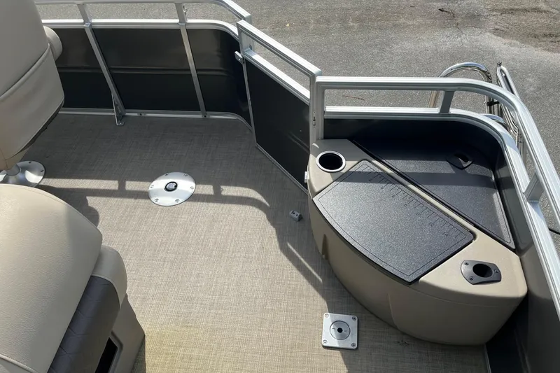 Slide: The Image of 2025 Sun Tracker Fishin' Barge 20 DLX interior with seating and storage compartments. - 7