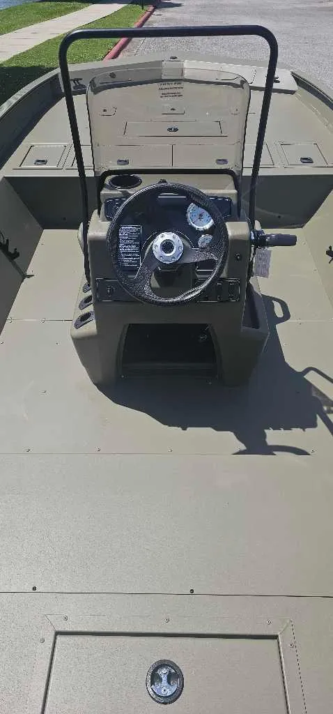 Slide: The Image of 2025 Tracker Grizzly 2072 CC boat interior with steering console and spacious deck. - 3