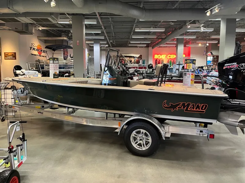 Slide: The Image of 2025 Mako 18 Pro Skiff Backwater Edition boat displayed in showroom. - 1