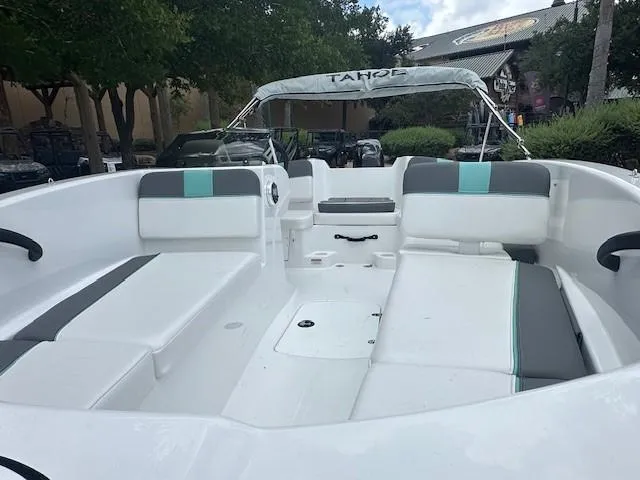 Slide: The Image of 2025 Tahoe T16 boat interior with white and gray seating, outdoor setting. - 2