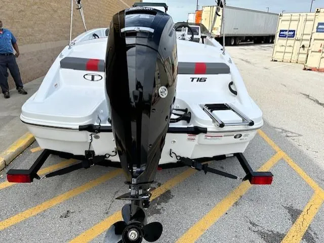 Slide: The Image of 2025 Tahoe T16 boat with outboard motor on trailer in parking lot. - 11