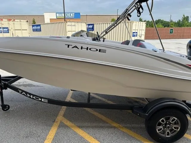 Slide: The Image of 2025 Tahoe T16 boat on trailer in parking lot. - 12