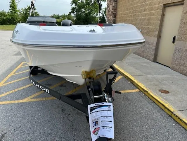 Slide: The Image of 2025 Tahoe T16 boat on trailer, parked outdoors near a building. - 6