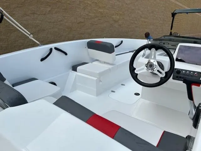 Slide: The Image of 2025 Tahoe T16 boat interior with modern steering and seating design. - 9