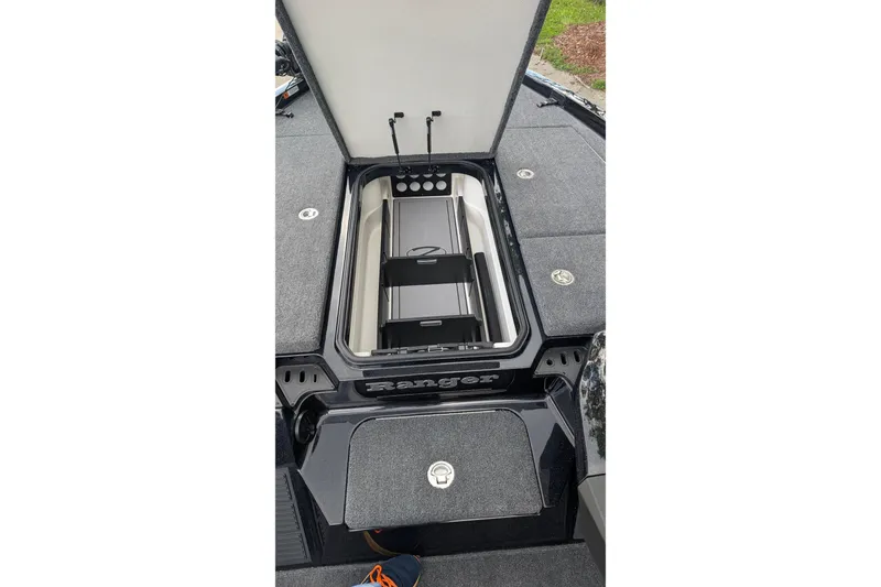 Slide: The Image of 2025 Ranger Z518 boat storage compartment with open lid, showcasing organized interior. - 14