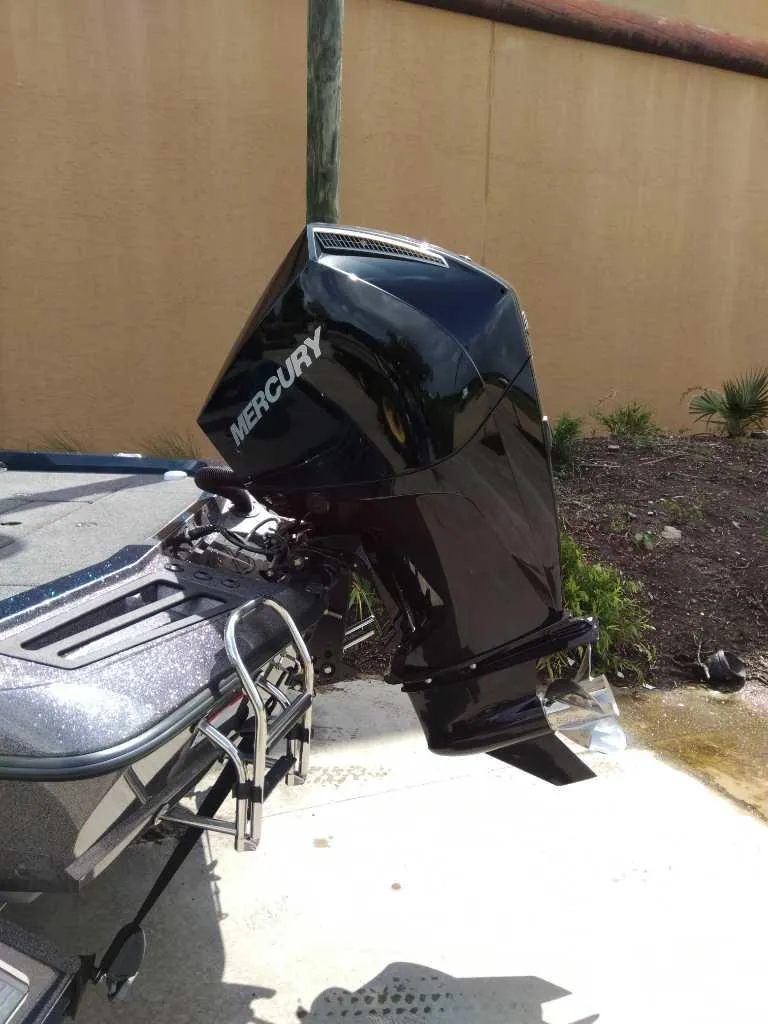 Slide: The Image of 2025 Ranger Z518 boat with Mercury outboard motor, parked outdoors. - 3