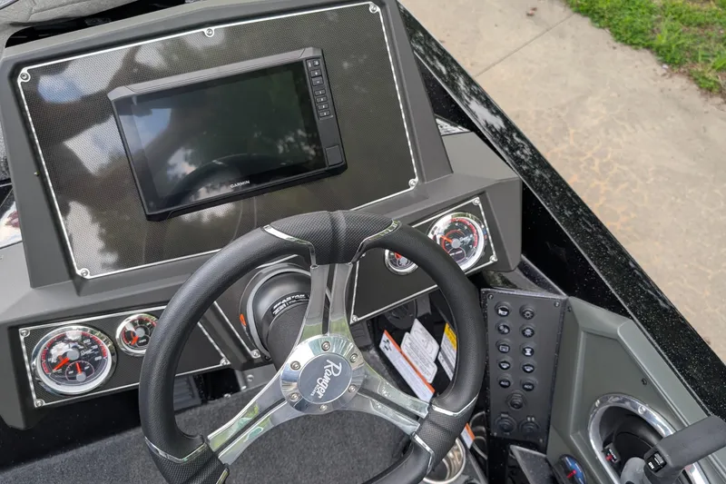 Slide: The Image of 2025 Ranger Z518 boat dashboard with steering wheel, gauges, and Garmin display. - 7