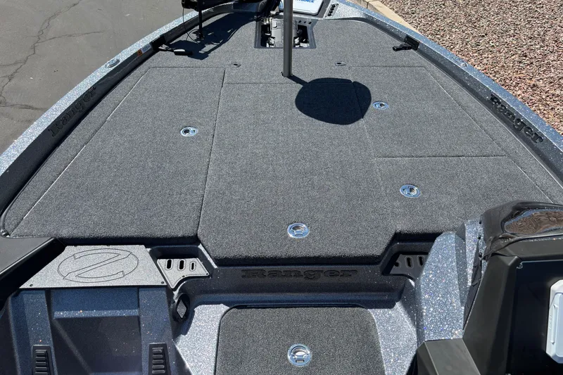 Slide: The Image of 2025 Ranger Z518 boat deck with carpeted surface and storage compartments. - 9