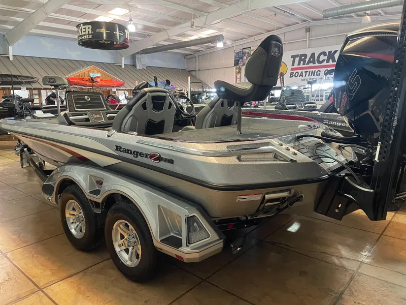 Slide: The Image of 2025 Ranger Z521R Cup-Equipped boat displayed in showroom, featuring sleek design and dual axles. - 2