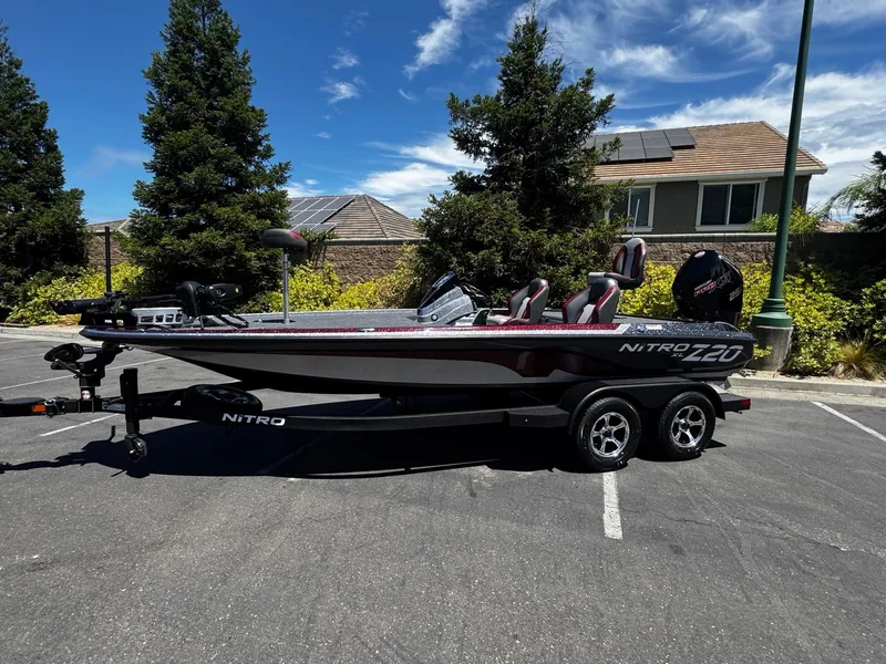 The Image of 2025 Nitro Z20 XL Pro boat on trailer in sunny parking lot. - 0