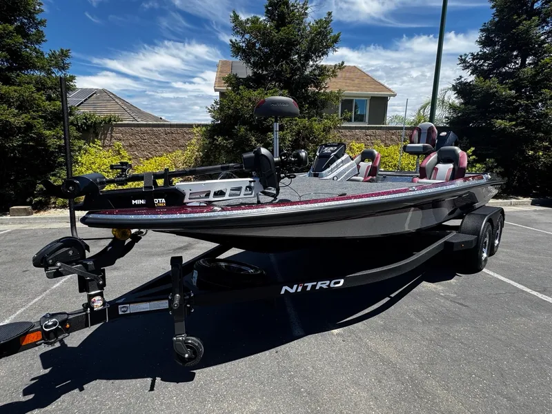 Slide: The Image of 2025 Nitro Z20 XL Pro boat on trailer, parked outdoors under clear sky. - 48