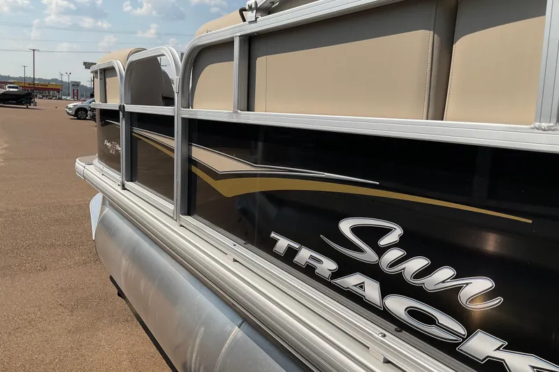 Slide: The Image of 2025 Sun Tracker Bass Buggy 16 XL Select pontoon boat in a parking lot. - 69