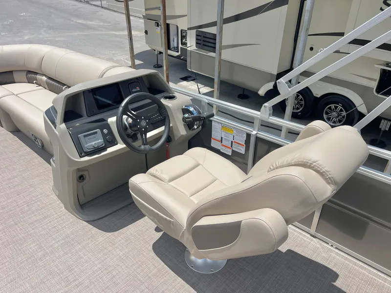 Slide: The Image of 2025 Sun Tracker Party Barge 20 DLX interior with steering console and captain's chair. - 4