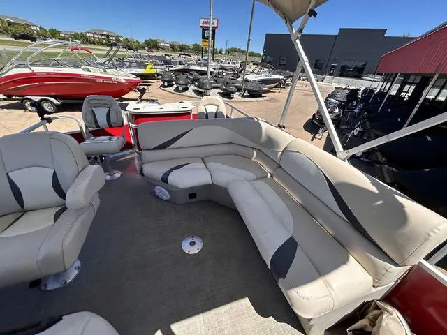 Slide: The Image of Interior of 2015 SunCatcher V20 F pontoon boat with beige seating, docked outdoors. - 10