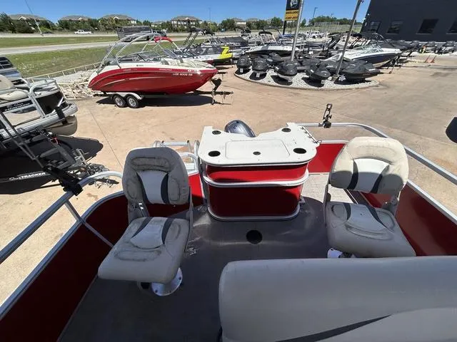 Slide: The Image of 2015 SunCatcher V20 F pontoon boat with seating, docked near other boats. - 12