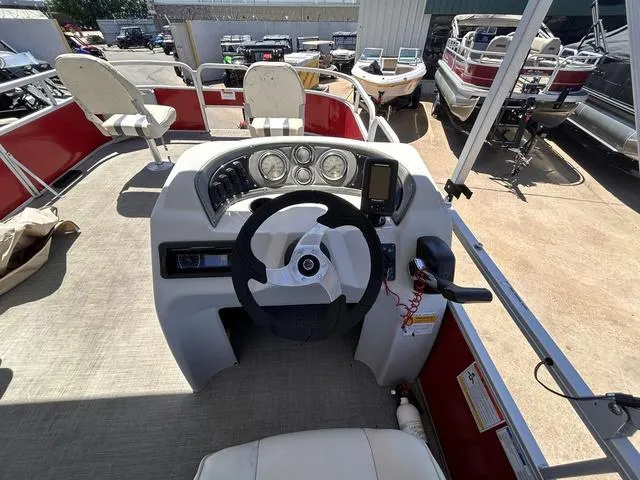 Slide: The Image of 2015 SunCatcher V20 F boat dashboard with steering wheel and gauges. - 14