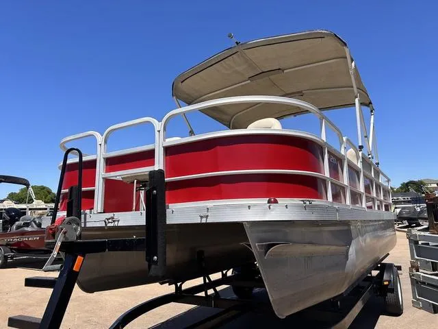 Slide: The Image of 2015 SunCatcher V20 F pontoon boat with red exterior and canopy on trailer. - 7