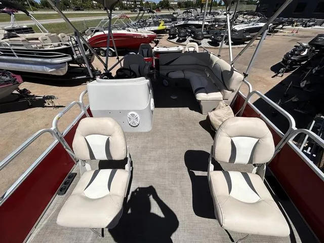 Slide: The Image of 2015 SunCatcher V20 F pontoon boat with spacious seating and helm, parked in a marina. - 8