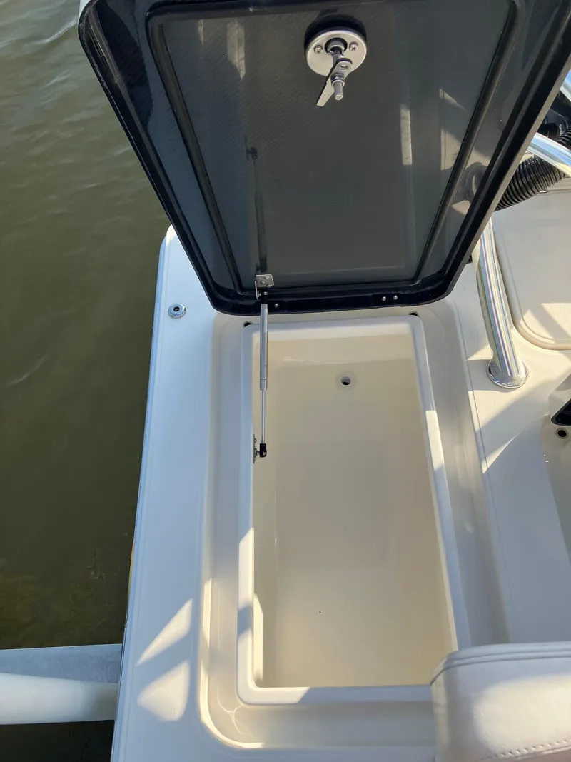 Slide: The Image of 2024 Islamorada Boatworks Morada 18 storage compartment with open hatch, showcasing interior space. - 10