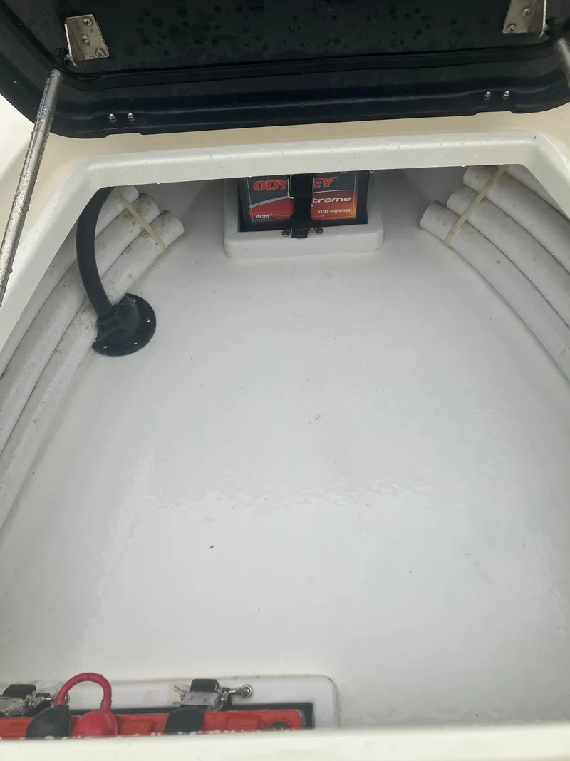 Slide: The Image of 2024 Islamorada Boatworks Morada 18 storage compartment with battery setup. - 12