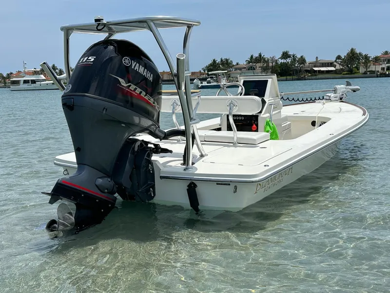Slide: The Image of 2024 Islamorada Boatworks Morada 18 in shallow water, featuring a Yamaha outboard motor. - 2