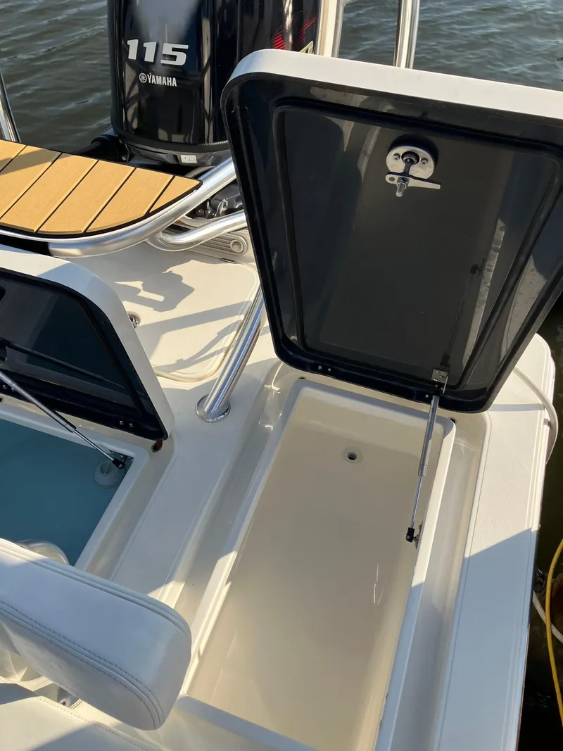 Slide: The Image of 2024 Islamorada Boatworks Morada 18 with Yamaha 115 engine, open storage compartment. - 9