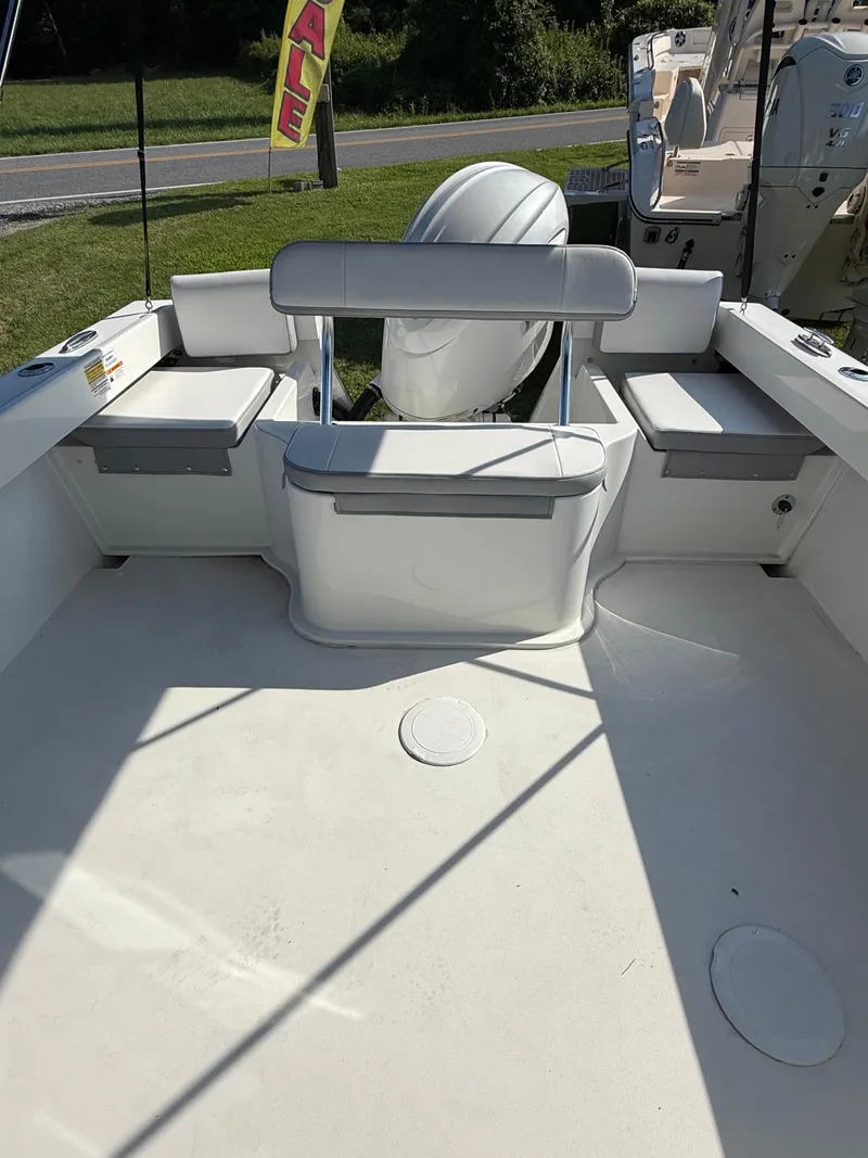 Slide: The Image of 2025 Parker 2120 Sport Cabin boat interior with seating and outboard motor. - 5