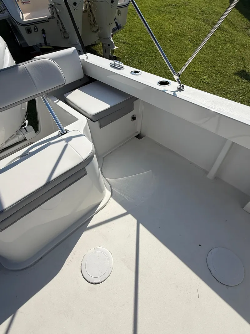 Slide: The Image of Parker 2120 Sport Cabin 2025 interior with seating and rod holders. - 6