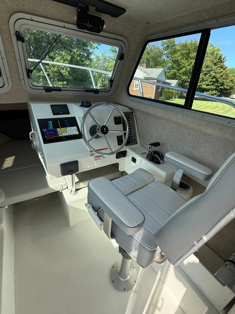Slide: The Image of 2025 Parker 2120 Sport Cabin interior with steering wheel and navigation display. - 8