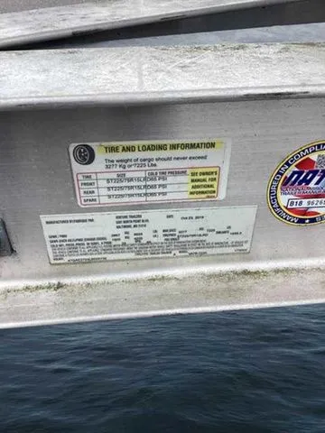 Slide: The Image of Tire and loading information label on a 2015 Crownline 264 CR boat. - 11