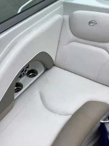 Slide: The Image of 2015 Crownline 264 CR boat interior with white and beige seating and cup holders. - 23