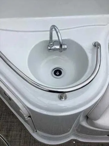 Slide: The Image of 2015 Crownline 264 CR boat sink with chrome faucet and railing. - 28