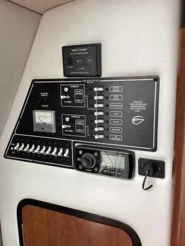Slide: The Image of Control panel of a 2015 Crownline 264 CR boat with switches and gauges. - 29