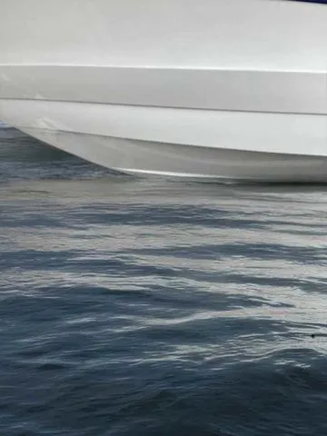 Slide: The Image of 2015 Crownline 264 CR boat hull on calm water surface. - 30