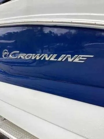 Slide: The Image of 2015 Crownline 264 CR boat with blue and white exterior detailing. - 5
