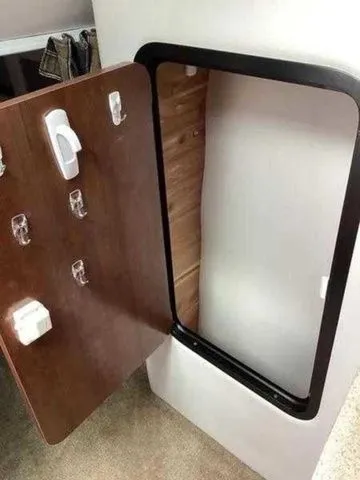 Slide: The Image of 2015 Crownline 264 CR cabin door with hooks and storage space. - 9