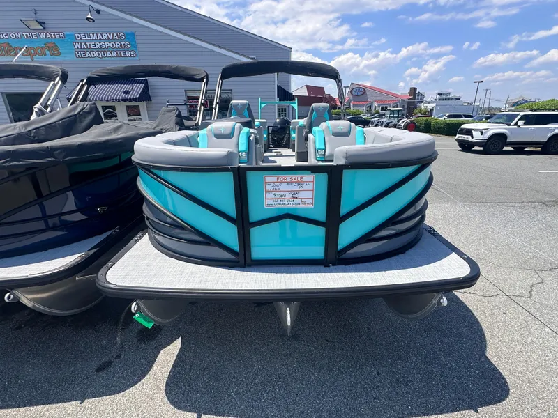 Slide: The Image of 2025 Berkshire 23RFX STS 3.0 pontoon boat in a dealership lot, sunny day. - 1