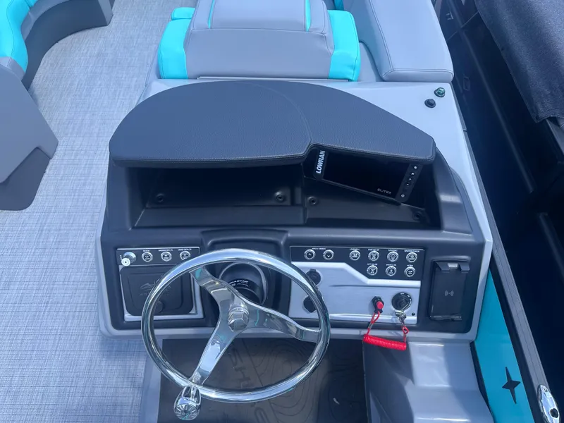 Slide: The Image of 2025 Berkshire 23RFX STS 3.0 boat dashboard with steering wheel and control panel. - 12
