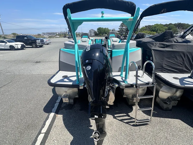 Slide: The Image of 2025 Berkshire 23RFX STS 3.0 pontoon boat with outboard motor in a parking lot. - 5