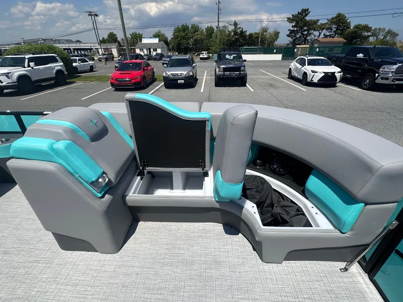 Slide: The Image of 2025 Berkshire 23RFX STS 3.0 boat interior with teal and gray seating in a parking lot. - 7